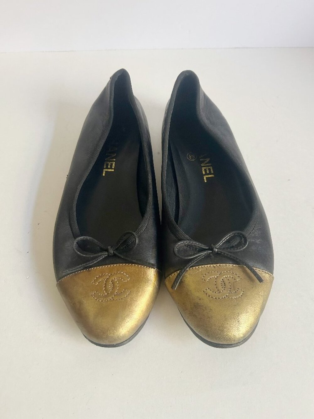CHANEL Black Leather Ballet Flats with Gold Cap Toes